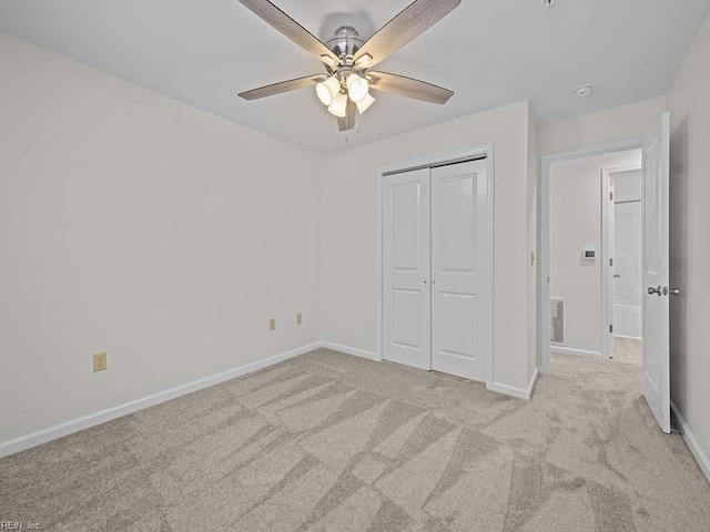 unfurnished bedroom featuring carpet flooring, baseboards, and a closet