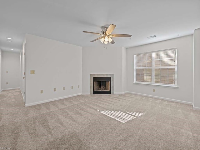 unfurnished living room featuring visible vents, a ceiling fan, carpet flooring, a fireplace, and baseboards