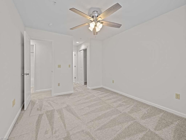 unfurnished bedroom with baseboards, recessed lighting, ceiling fan, a closet, and light carpet