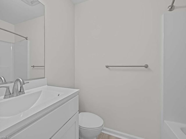 full bath featuring vanity, toilet, wood finished floors, and baseboards