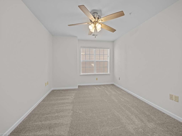 spare room with carpet, baseboards, and ceiling fan