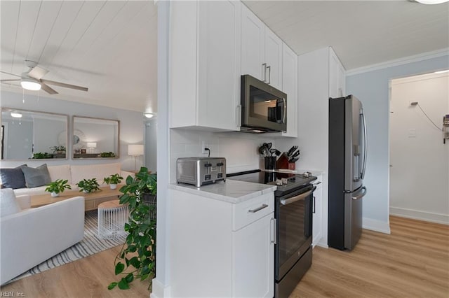 kitchen featuring white cabinetry, backsplash, light hardwood / wood-style floors, stainless steel appliances, and crown molding