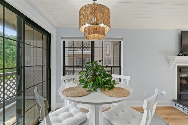 dining space with hardwood / wood-style flooring and a chandelier