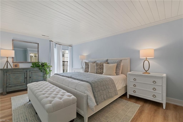 bedroom featuring ornamental molding, wooden ceiling, and light hardwood / wood-style floors