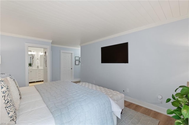 bedroom with ornamental molding, ensuite bathroom, and light wood-type flooring