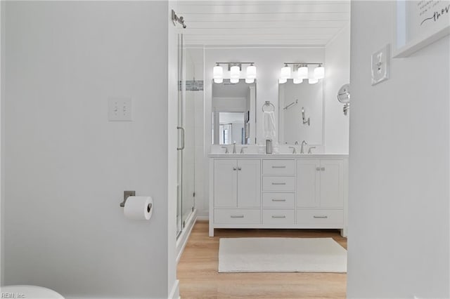 bathroom with vanity, hardwood / wood-style floors, and walk in shower