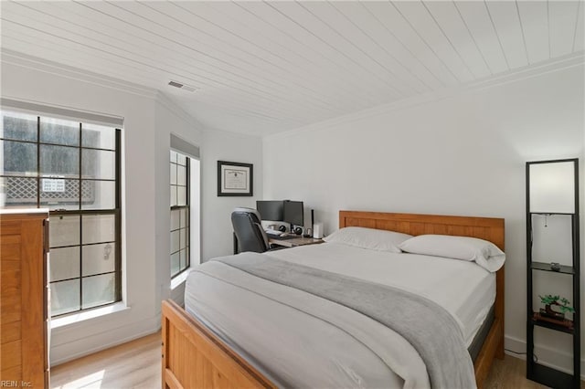 bedroom featuring crown molding, light hardwood / wood-style flooring, and wooden ceiling