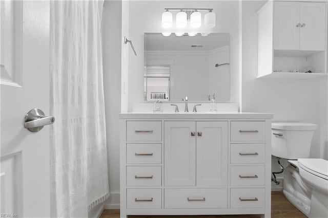 bathroom featuring hardwood / wood-style floors, vanity, ornamental molding, a shower with curtain, and toilet