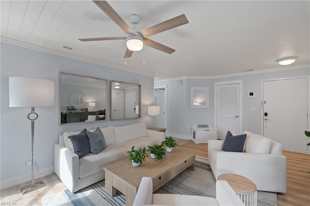 living room with crown molding, ceiling fan, and light hardwood / wood-style floors