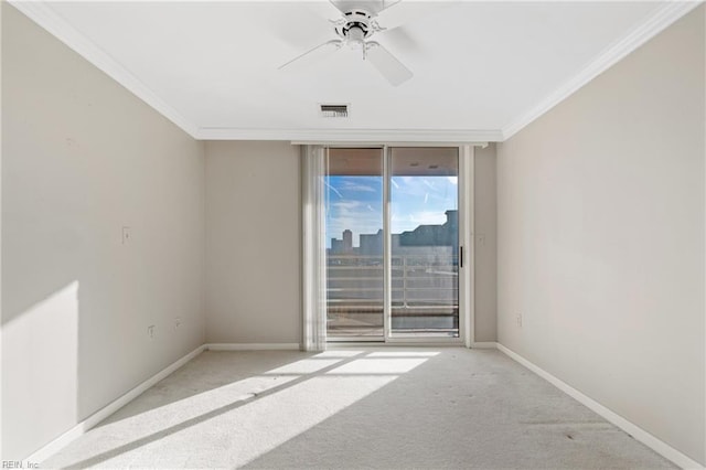 carpeted spare room with crown molding and ceiling fan