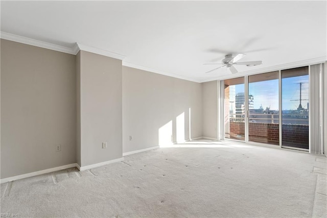 spare room with ceiling fan, ornamental molding, and light carpet