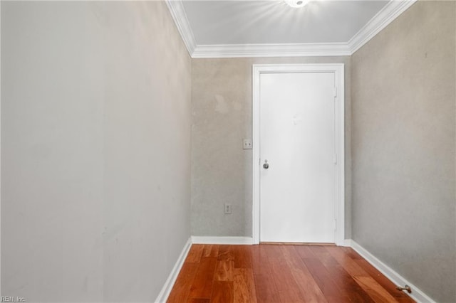 entryway with hardwood / wood-style flooring and ornamental molding