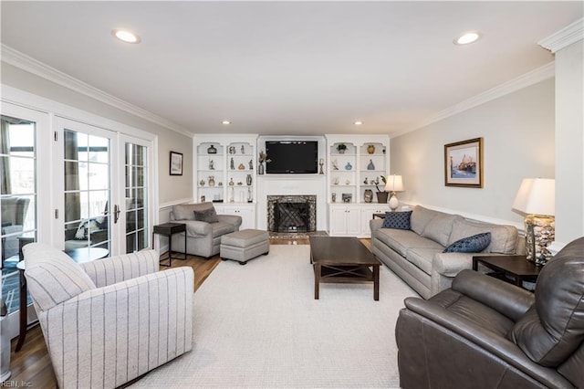 living room featuring crown molding, hardwood / wood-style floors, and french doors