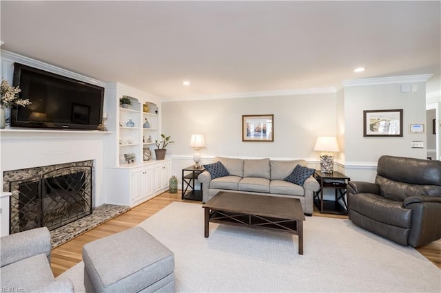 living room featuring light hardwood / wood-style flooring and ornamental molding