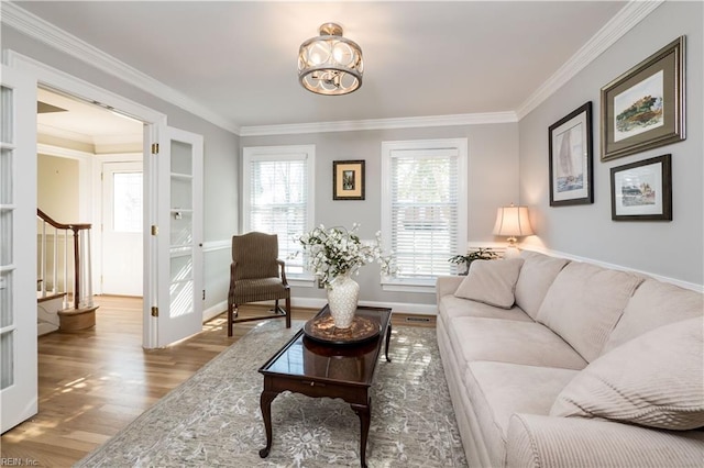 living room featuring crown molding and light wood-type flooring