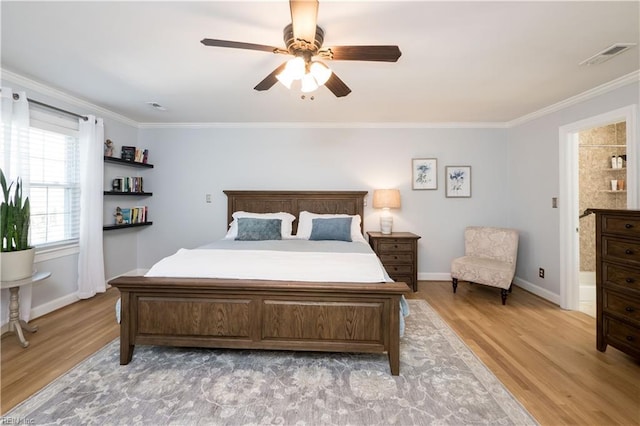 bedroom featuring ceiling fan, ornamental molding, and light wood-type flooring