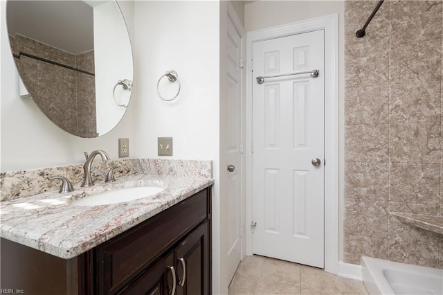 bathroom with vanity, tile patterned flooring, and tiled shower