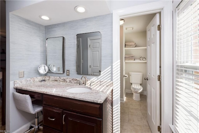 bathroom with vanity, tile patterned floors, and toilet