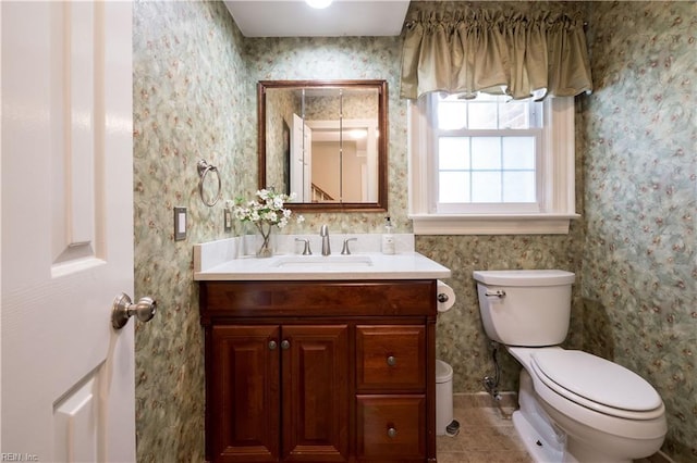 bathroom with vanity, tile patterned floors, and toilet