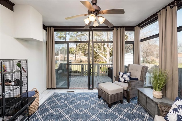 sunroom / solarium with plenty of natural light and ceiling fan