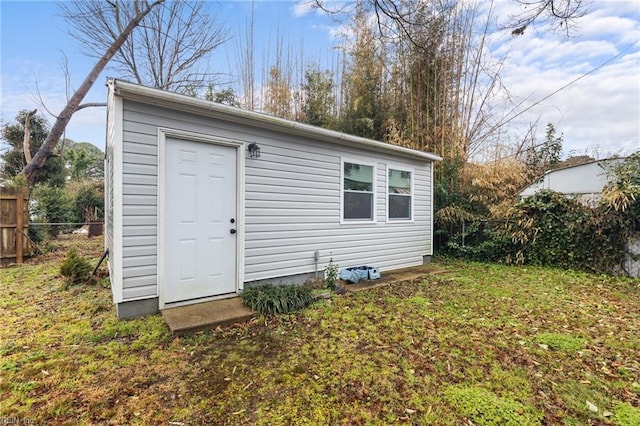 view of outbuilding featuring a yard