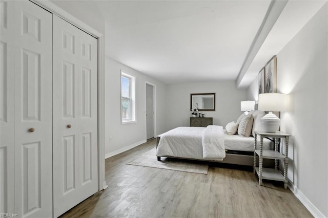 bedroom with a closet and light hardwood / wood-style flooring