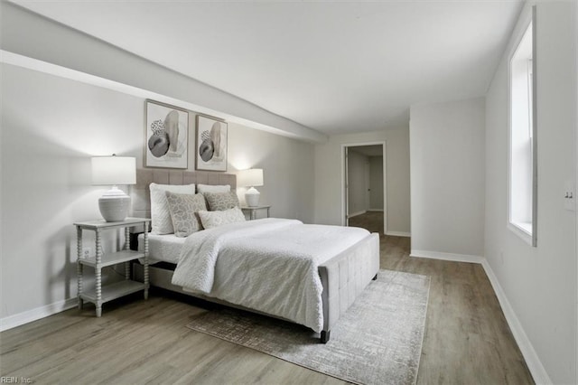 bedroom featuring lofted ceiling and hardwood / wood-style floors