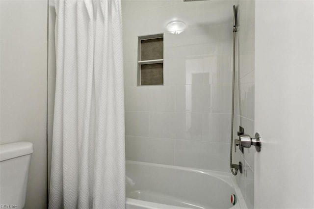 bathroom with toilet and shower / bath combo