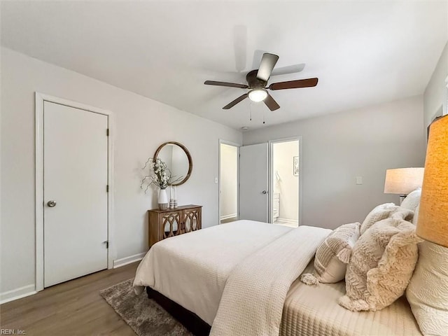 bedroom with ensuite bath, wood-type flooring, and ceiling fan