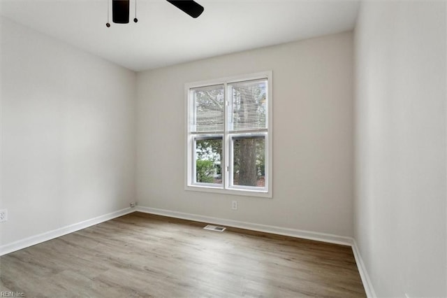 spare room featuring hardwood / wood-style floors and ceiling fan