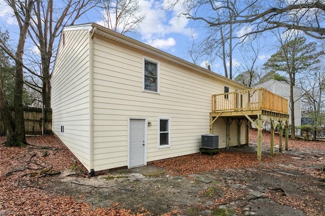 back of property featuring a wooden deck and central AC