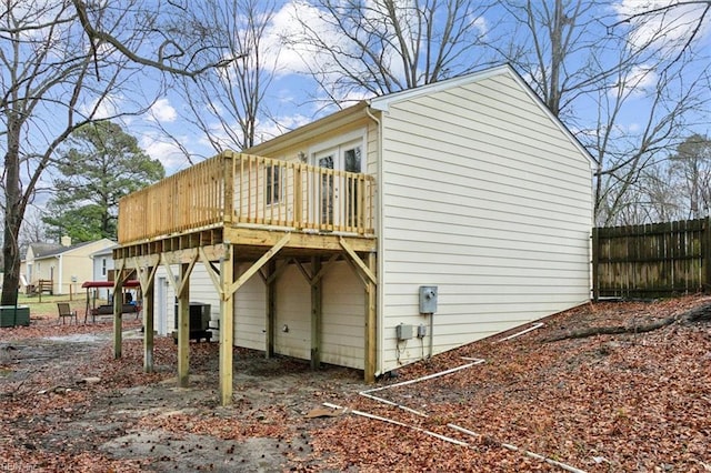 view of side of property with a deck and central air condition unit