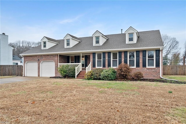 new england style home with a garage, covered porch, and a front lawn