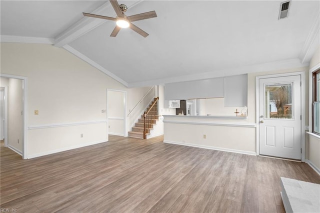 unfurnished living room with ceiling fan, ornamental molding, vaulted ceiling with beams, and light wood-type flooring