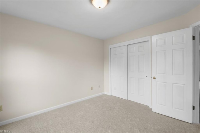 unfurnished bedroom with carpet flooring and a closet