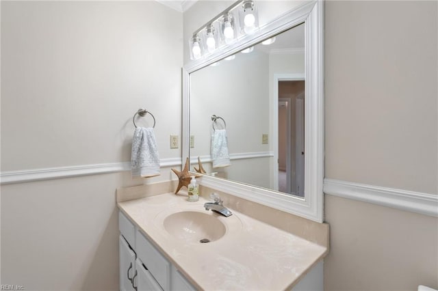 bathroom featuring vanity and ornamental molding