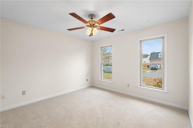 spare room with light carpet and ceiling fan