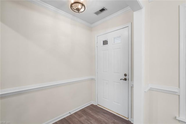 entrance foyer featuring dark wood-type flooring and ornamental molding