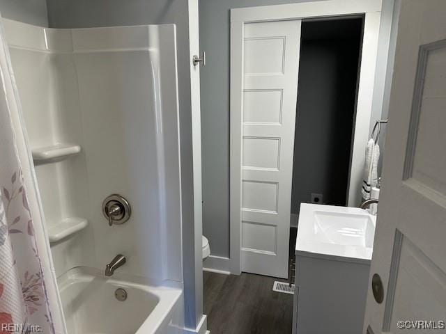 full bathroom with vanity, wood-type flooring, toilet, and shower / bath combo