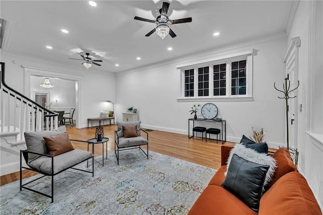 living room with crown molding, ceiling fan, and wood-type flooring