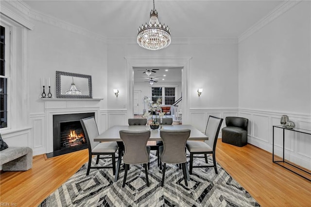 dining room with crown molding, a notable chandelier, and hardwood / wood-style flooring