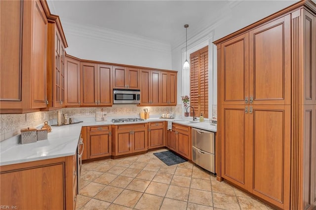 kitchen with sink, crown molding, decorative light fixtures, stainless steel appliances, and decorative backsplash