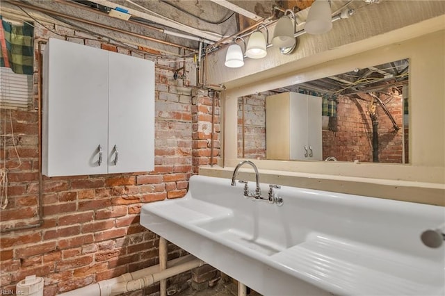 bathroom featuring brick wall