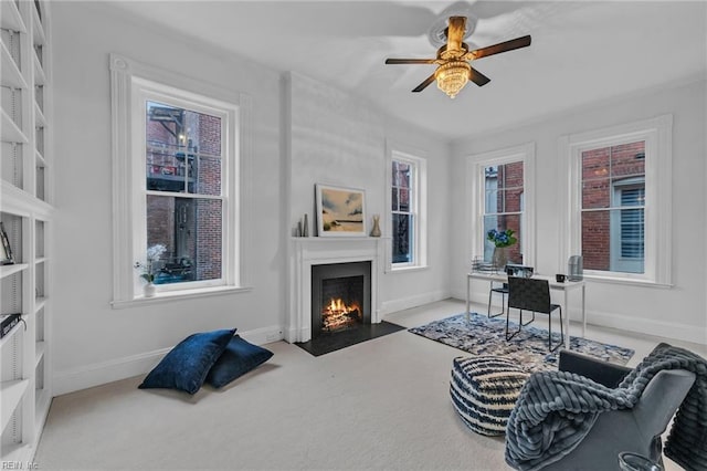 sitting room with carpet flooring and ceiling fan