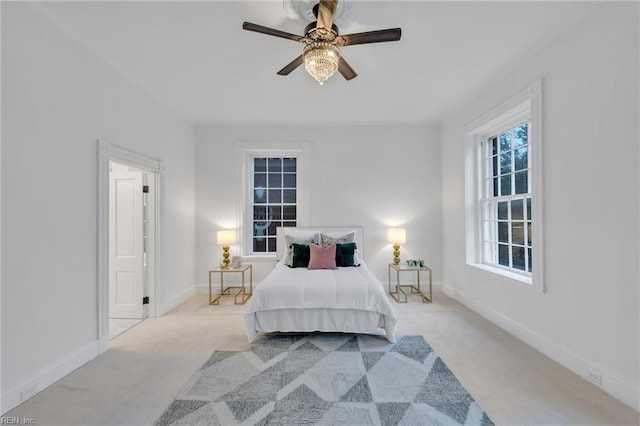 bedroom with light carpet and ceiling fan