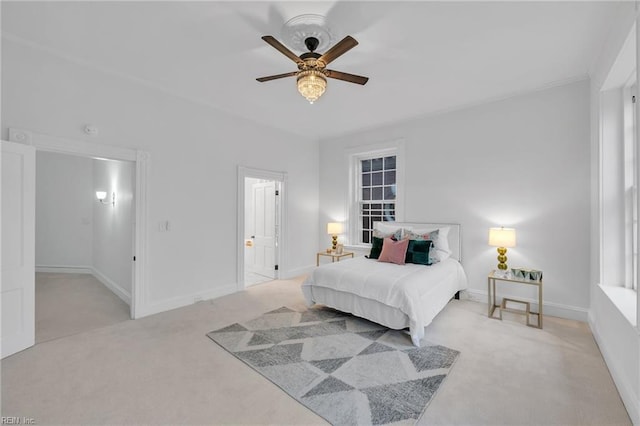 carpeted bedroom featuring ceiling fan and ensuite bath