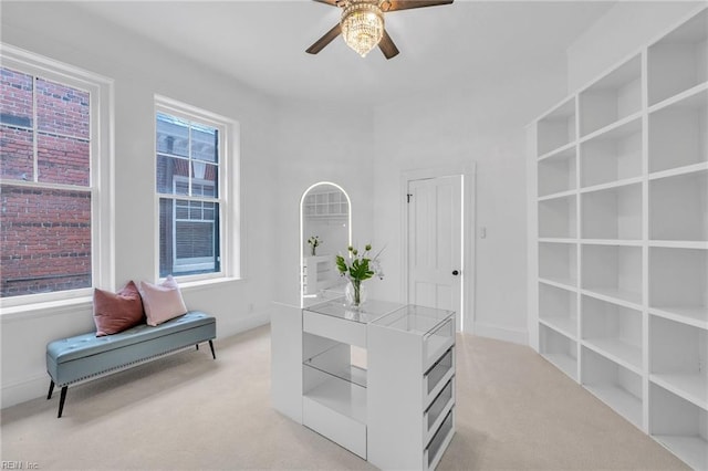 interior space featuring light colored carpet and ceiling fan