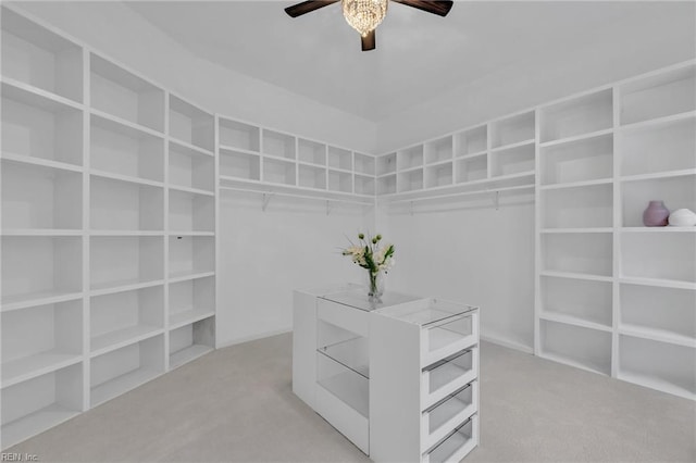 spacious closet with light colored carpet and ceiling fan