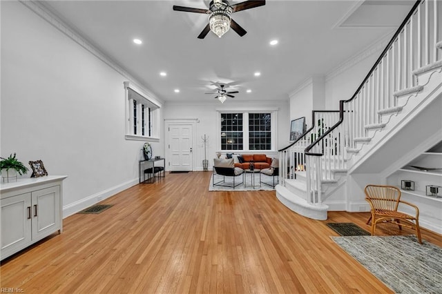 living room with crown molding, light hardwood / wood-style floors, and ceiling fan