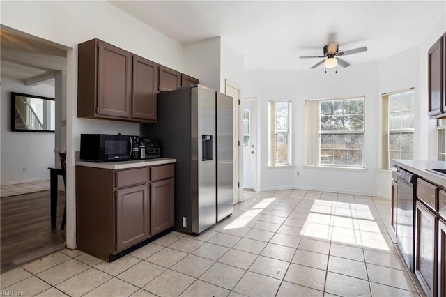 kitchen with ceiling fan, light tile patterned floors, dark brown cabinets, and black appliances